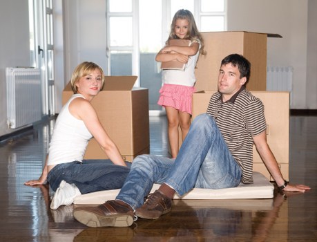 Trained moving staff lifting furniture carefully with protective equipment